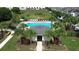 Aerial view of the community pool surrounded by palm trees and manicured landscaping at 943 Grandin St, Davenport, FL 33837