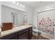 Full bathroom with a vanity, a large mirror, and a shower with a decorative floral curtain at 943 Grandin St, Davenport, FL 33837