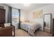 Cozy bedroom with a single bed, a world map wall hanging, and a large window with blinds at 943 Grandin St, Davenport, FL 33837