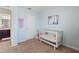 Light and airy Bedroom featuring a white crib, blue walls, and carpet flooring at 943 Grandin St, Davenport, FL 33837
