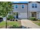 Charming two-story townhome with a one-car garage and a well-maintained front yard at 943 Grandin St, Davenport, FL 33837