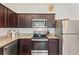 Well-equipped kitchen with stainless steel appliances and dark wood cabinets at 943 Grandin St, Davenport, FL 33837