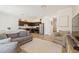 Cozy living space with hardwood floors seamlessly connecting to a modern kitchen at 943 Grandin St, Davenport, FL 33837