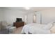 Calm main bedroom with plush bed, a dresser with TV, and neutral decor for a relaxing retreat at 943 Grandin St, Davenport, FL 33837