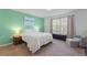 Inviting main bedroom with a plush bed, soothing green accent wall, and window for natural light at 943 Grandin St, Davenport, FL 33837