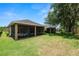 Lush backyard view featuring an expansive lawn and screened porch area, perfect for outdoor enjoyment at 961 Christina Chase Dr, Lakeland, FL 33813