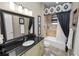Stylish bathroom featuring a vanity with granite countertops and a tub with shower at 961 Christina Chase Dr, Lakeland, FL 33813