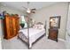Cozy bedroom featuring a four-poster bed, decorative accents, and a ceiling fan at 961 Christina Chase Dr, Lakeland, FL 33813