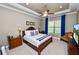 Serene bedroom featuring a plush bed, tray ceiling, and a cozy sitting area at 961 Christina Chase Dr, Lakeland, FL 33813