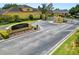Entrance to Christina Chase featuring lush landscaping and gated access at 961 Christina Chase Dr, Lakeland, FL 33813