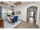 Charming dining room showcasing tray ceilings, a chandelier, and hardwood floors at 961 Christina Chase Dr, Lakeland, FL 33813