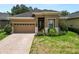 Charming home featuring a brick-paved driveway and meticulously maintained landscaping at 961 Christina Chase Dr, Lakeland, FL 33813