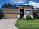 Well-maintained single Gathering home with a brick driveway, tidy landscaping, and a two car garage at 961 Christina Chase Dr, Lakeland, FL 33813