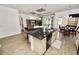 Modern kitchen with a large island, stainless steel sink, and lots of counter space overlooking the living room at 961 Christina Chase Dr, Lakeland, FL 33813