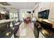 Open kitchen featuring an island with black granite counters and modern appliances at 961 Christina Chase Dr, Lakeland, FL 33813