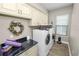 Efficient laundry room with ample storage, modern appliances, and a sleek countertop at 961 Christina Chase Dr, Lakeland, FL 33813