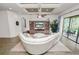 Bright living room featuring a large sectional, entertainment center, and sliding doors to the patio at 961 Christina Chase Dr, Lakeland, FL 33813