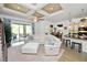 Bright living room with coffered ceiling, a large sectional, and access to a screened-in patio at 961 Christina Chase Dr, Lakeland, FL 33813