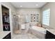 Bright bathroom features a walk-in shower, soaking tub, and access to the walk-in closet at 961 Christina Chase Dr, Lakeland, FL 33813