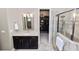 Elegant bath with walk-in shower, granite counters, a dark vanity, and a large closet at 961 Christina Chase Dr, Lakeland, FL 33813