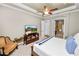 Spacious bedroom features a ceiling fan and television, with access to the main bath at 961 Christina Chase Dr, Lakeland, FL 33813