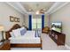 Bright main bedroom features a ceiling fan, television, and view of the exterior at 961 Christina Chase Dr, Lakeland, FL 33813