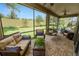 Spacious screened-in patio with brick floors, multiple seating areas, and a tranquil view of the green backyard at 961 Christina Chase Dr, Lakeland, FL 33813
