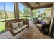 Relaxing screened-in patio featuring a porch swing, comfortable seating, and views of the manicured backyard at 961 Christina Chase Dr, Lakeland, FL 33813