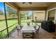 Inviting screened-in patio with dining area and views of the beautifully landscaped backyard at 961 Christina Chase Dr, Lakeland, FL 33813