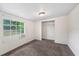 Cozy bedroom features neutral carpet, natural light, and closet for ample storage at 1133 Bryn Mawr Ave, Lake Wales, FL 33853
