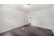 Bedroom featuring new carpet, neutral paint, and access to closet at 1133 Bryn Mawr Ave, Lake Wales, FL 33853