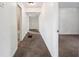 Bright hallway showcasing neutral tones and access to various rooms in the home at 1133 Bryn Mawr Ave, Lake Wales, FL 33853
