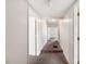 Neutral-toned hallway with carpet features white walls and white doors leading to other rooms at 1133 Bryn Mawr Ave, Lake Wales, FL 33853