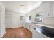 Classic kitchen with white cabinets, laminate floors, stainless steel sink, and bright natural light at 1133 Bryn Mawr Ave, Lake Wales, FL 33853