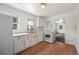 Bright kitchen featuring white appliances, ample cabinet space, and wood flooring at 1133 Bryn Mawr Ave, Lake Wales, FL 33853