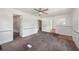 Spacious living room featuring fresh carpet, ceiling fan and classic wainscoting at 1133 Bryn Mawr Ave, Lake Wales, FL 33853