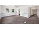 Spacious living room with fresh carpet, wainscoting, a ceiling fan and lots of natural light at 1133 Bryn Mawr Ave, Lake Wales, FL 33853