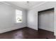Simple bedroom with gray walls and wooden floors, with a closet at 121 F Sw Ave, Winter Haven, FL 33880