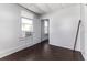 Bedroom with dark wood floors featuring an open doorway at 121 F Sw Ave, Winter Haven, FL 33880