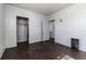 Bedroom with dark hardwood floors, closet, and staircase access at 121 F Sw Ave, Winter Haven, FL 33880