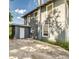 Exterior elevation of home featuring concrete parking area and home access door at 121 F Sw Ave, Winter Haven, FL 33880