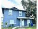 Two-story home featuring a front porch, a well-maintained yard, and a large tree at 121 F Sw Ave, Winter Haven, FL 33880