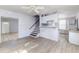 Kitchen with light grey cabinets, a breakfast bar and stair access to the 2nd floor at 121 F Sw Ave, Winter Haven, FL 33880