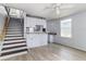 Kitchen with light grey cabinets, a breakfast bar and stair access to the 2nd floor at 121 F Sw Ave, Winter Haven, FL 33880