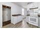 White kitchen cabinets with laminate countertops and floors, along with white appliances at 121 F Sw Ave, Winter Haven, FL 33880