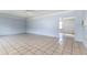 Spacious living room featuring tiled floors, fresh paint, and ceiling fan at 121 F Sw Ave, Winter Haven, FL 33880