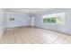 Bright living room with tiled floors, and large window providing ample light at 121 F Sw Ave, Winter Haven, FL 33880
