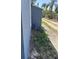 Exterior side yard featuring new planting bed and concrete sidewalk to the backyard at 121 F Sw Ave, Winter Haven, FL 33880