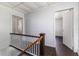 Stairwell with access to the lower level and wood railing at 121 F Sw Ave, Winter Haven, FL 33880