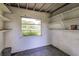 Bright storage room with built in shelving and a window with a view of the grounds at 121 F Sw Ave, Winter Haven, FL 33880